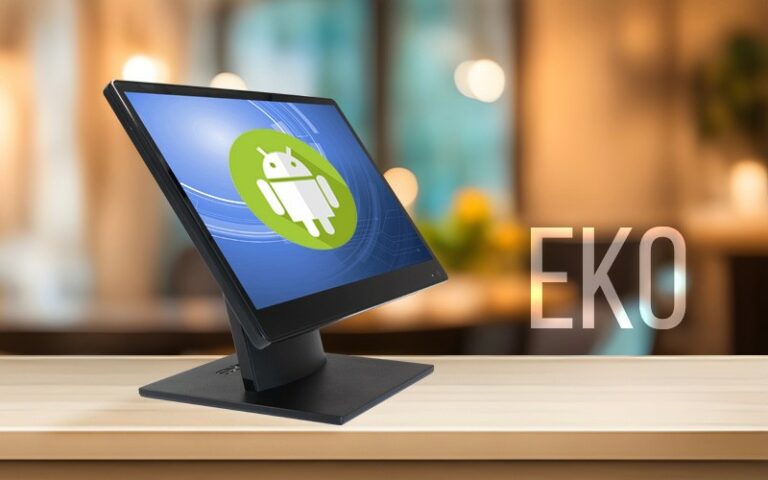 A sleek black monitor displaying the EKO Android EPOS logo on its screen sits elegantly on a wooden surface. The background is softly blurred with warm lighting, and the word AURES is prominently shown next to the monitor.