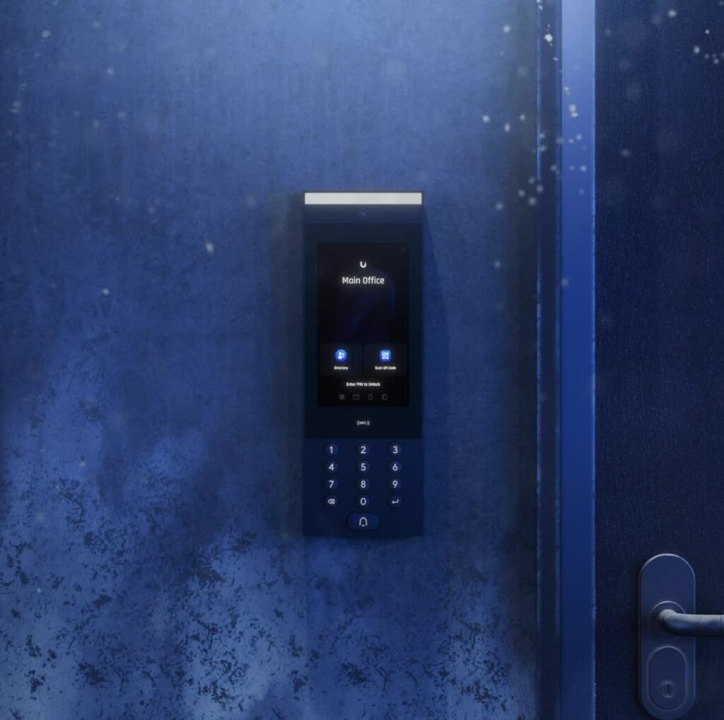 A digital keypad access panel, resembling a UniFi Access Intercom, is mounted on a textured blue wall near a door handle. The panels screen displays Main office with icons below it, offering seamless integration and security by Ubiquiti.