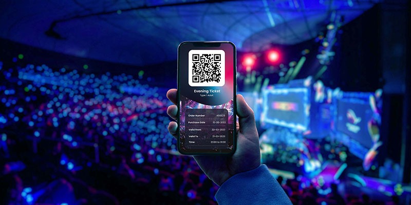 A hand holds a smartphone displaying a QR code and ticket details, enhanced by EPOS software, against a vibrant concert venue. The background is alive with colourful lights and an audience engrossed in the stages large screens.