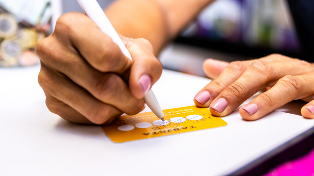 Customer hands collecting points on a loyalty card
