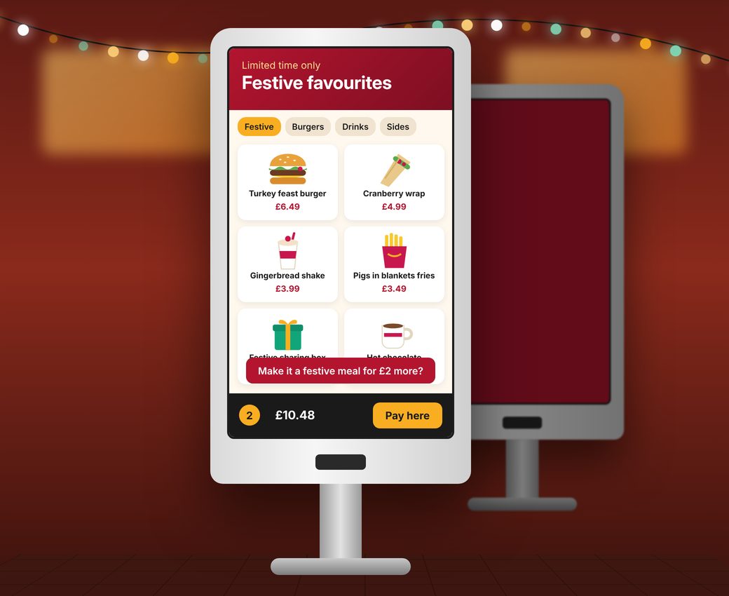 Self-service kiosk showing a festive favourites menu with a meal deal prompt