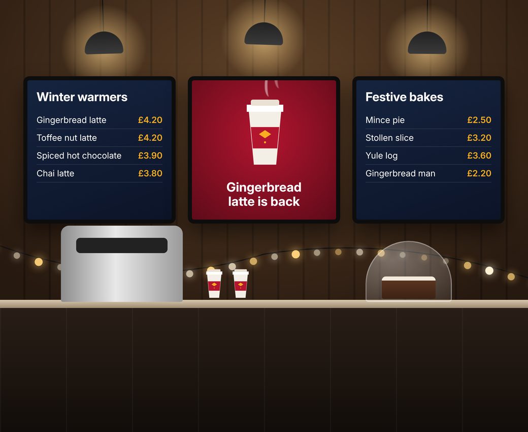 Coffee shop digital menu boards showing winter warmers and festive bakes